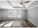 This bedroom features three windows and a modern ceiling fan, offering plenty of natural light at 3804 Prince Noah, Wake Forest, NC 27587