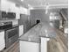 Eat-in kitchen features stainless steel appliances, granite countertops, and a breakfast bar with pendant lighting at 3804 Prince Noah, Wake Forest, NC 27587