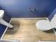 Powder room featuring blue walls, decorative flooring, modern toilet and pedestal sink at 3804 Prince Noah, Wake Forest, NC 27587
