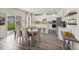 Open-concept dining area with a view of the kitchen and sliding glass doors that lead to outdoor space at 3833 Rosebush Dr, Zebulon, NC 27597