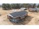 Aerial of a brick ranch home with an attached carport, storage buildings, and a spacious yard at 4459 N Old Carriage Rd, Rocky Mount, NC 27804