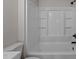 Clean bathroom with a full shower and tub combo, featuring sleek fixtures and bright lighting at 4459 N Old Carriage Rd, Rocky Mount, NC 27804