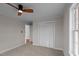 Comfortable bedroom with a ceiling fan and closet featuring standard doors for optimal storage at 4459 N Old Carriage Rd, Rocky Mount, NC 27804