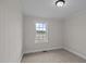 Bright bedroom with carpet and a single window offering views of the outside, next to the yard at 4459 N Old Carriage Rd, Rocky Mount, NC 27804