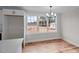 Bright dining area with expansive windows overlooking the yard and a modern chandelier at 4459 N Old Carriage Rd, Rocky Mount, NC 27804