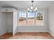 The dining area boasts large windows and hardwood floors for a cozy and inviting atmosphere at 4459 N Old Carriage Rd, Rocky Mount, NC 27804