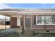 Up close, the brick home features a covered porch and large window at 4459 N Old Carriage Rd, Rocky Mount, NC 27804