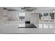 Modern kitchen with white cabinets, quartz counters, stainless appliances and sleek cooktop at 4459 N Old Carriage Rd, Rocky Mount, NC 27804