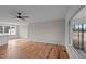 Bright living room with hardwood floors, ceiling fan and large windows offering natural light at 4459 N Old Carriage Rd, Rocky Mount, NC 27804