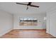 Bright living room with hardwood floors, ceiling fan and large windows offering natural light at 4459 N Old Carriage Rd, Rocky Mount, NC 27804