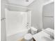 This bathroom features a shower and tub combination and neutral tiling at 4820 Landover Arbor Pl, Raleigh, NC 27616