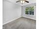 Cozy bedroom with a ceiling fan and a large window overlooking the outdoors at 4820 Landover Arbor Pl, Raleigh, NC 27616