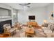 Bright, staged living room with fireplace, ceiling fan, and stylish furnishings at 4820 Landover Arbor Pl, Raleigh, NC 27616