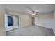 Neutral bedroom offers comfortable carpeting, a ceiling fan, and sliding glass doors leading to the outdoor patio at 4911 Hollenden Dr, Raleigh, NC 27616