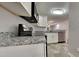 Modern kitchen features stainless steel appliances, light countertops, and a view into the living area, perfect for entertaining at 4911 Hollenden Dr, Raleigh, NC 27616