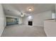Spacious living room boasts a cozy fireplace, neutral decor, new carpet, and access to the outdoor patio for seamless indoor-outdoor living at 4911 Hollenden Dr, Raleigh, NC 27616