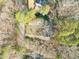 An aerial view shows the house surrounded by trees, with a long driveway and a well-manicured front yard at 5620 Winthrop Dr, Raleigh, NC 27612