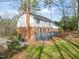 This spacious backyard features a beautiful brick home, a well-maintained lawn, and an attractive grey deck at 5620 Winthrop Dr, Raleigh, NC 27612