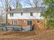 Backyard view of the house with a deck, patio, and lush greenery at 5620 Winthrop Dr, Raleigh, NC 27612