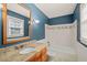 Bathroom featuring blue walls, a granite countertop, and a combined shower and tub at 5620 Winthrop Dr, Raleigh, NC 27612