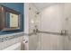 Bathroom featuring tile shower with glass door and brushed nickel fixtures at 5620 Winthrop Dr, Raleigh, NC 27612