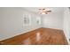 Bright bedroom with hardwood floors, two windows, and a ceiling fan at 5620 Winthrop Dr, Raleigh, NC 27612