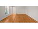 Open bedroom featuring neutral walls and hardwood flooring at 5620 Winthrop Dr, Raleigh, NC 27612