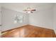 Empty bedroom featuring hardwood floors, fresh paint, and ample natural light at 5620 Winthrop Dr, Raleigh, NC 27612