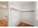 Walk-in closet featuring white shelving and hardwood floors for clothing and accessory storage at 5620 Winthrop Dr, Raleigh, NC 27612