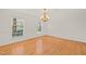 Bright dining room with hardwood floors, large windows, and elegant chandelier at 5620 Winthrop Dr, Raleigh, NC 27612