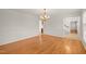 Formal dining room featuring hardwood floors, chandelier, and decorative wall trim at 5620 Winthrop Dr, Raleigh, NC 27612