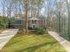 Classic brick home with a long driveway and lush greenery, showing its curb appeal at 5620 Winthrop Dr, Raleigh, NC 27612