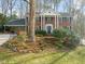 Charming brick home with white columns, black shutters, and a well-manicured front yard at 5620 Winthrop Dr, Raleigh, NC 27612