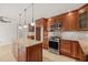 Gourmet kitchen features stainless steel appliances, custom cabinets and granite countertops at 5620 Winthrop Dr, Raleigh, NC 27612