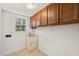Functional laundry room with built-in cabinets and sink at 5620 Winthrop Dr, Raleigh, NC 27612