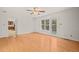 Open living room with hardwood floors, direct access to back patio, and lots of natural light at 5620 Winthrop Dr, Raleigh, NC 27612