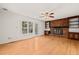 Living room features hardwood floors, brick fireplace and access to back deck at 5620 Winthrop Dr, Raleigh, NC 27612
