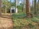 A detached outbuilding in the backyard with a star, offering extra storage space and unique charm at 5620 Winthrop Dr, Raleigh, NC 27612