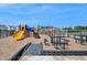 Colorful community playground including slides, jungle gyms, picnic tables, and surrounding homes at 616 Emerald Bay Cir, Raleigh, NC 27610
