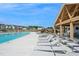Upscale pool area with ample lounge chairs, shade, and community playground in background at 616 Emerald Bay Cir, Raleigh, NC 27610