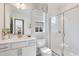 Clean bathroom featuring single vanity, walk-in shower, and natural light from a window at 625 Emerald Bay Cir, Raleigh, NC 27610