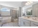 Elegant bathroom with a glass-enclosed shower, soaking tub, double vanity, and modern finishes at 625 Emerald Bay Cir, Raleigh, NC 27610