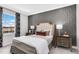 Bedroom with accent wall, side tables and window view at 625 Emerald Bay Cir, Raleigh, NC 27610