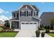 Charming two-story home with gray siding, black shutters, attached garage, and well-manicured lawn at 625 Emerald Bay Cir, Raleigh, NC 27610
