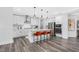 Modern kitchen with white cabinets, stainless steel appliances, island, and trendy pendant lighting at 625 Emerald Bay Cir, Raleigh, NC 27610