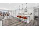 Stylish open-concept kitchen with white cabinets, island seating, and stainless steel appliances at 625 Emerald Bay Cir, Raleigh, NC 27610