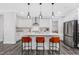 Bright kitchen featuring white cabinets, stainless steel appliances, a large island, and pendant lights at 625 Emerald Bay Cir, Raleigh, NC 27610