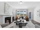 Bright living room with fireplace and large window, offering views of the outdoors at 625 Emerald Bay Cir, Raleigh, NC 27610