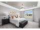 Bright bedroom featuring a designer ceiling, large window and a padded bench at the foot of the bed at 625 Emerald Bay Cir, Raleigh, NC 27610