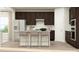 Modern kitchen boasts dark cabinets, a center island with seating, stainless steel appliances, and stylish countertops at 632 Emerald Bay Cir, Raleigh, NC 27610